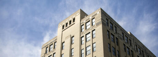 260 East 161st Street building upper floors framed against cloudy blue sky