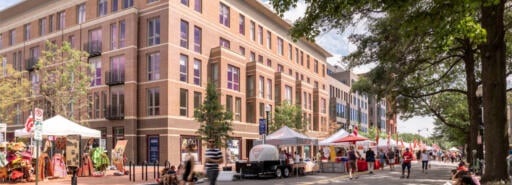 700 Penn building facade with street fair tents and pedestrians