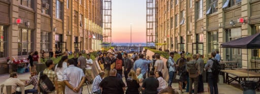 Industry City courtyard at dusk with attendees at an event