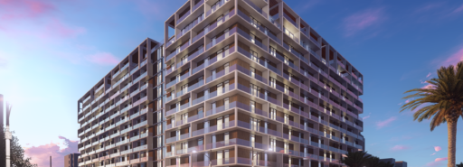 Rendering of apartment building with cars driving by and sunset sky behind