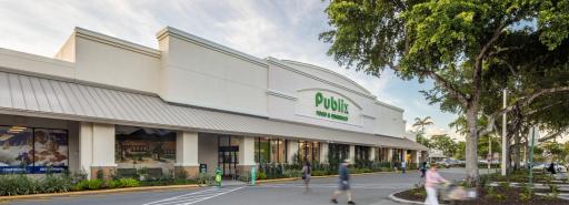 Publix grocery store exterior facade with pedestrians in driveway at Cypress Commons