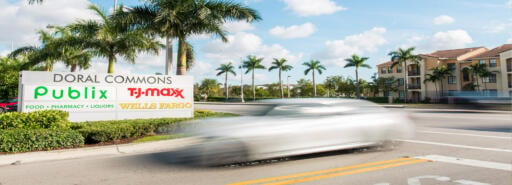 A car passes the entrance at Doral Commons