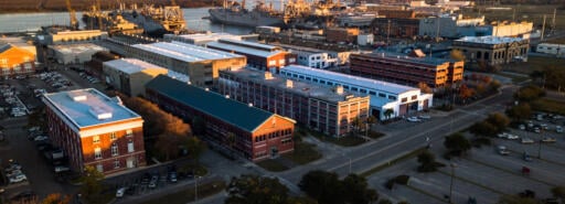 Aerial view of Navy Yard Charleston during dusk with waterway in background