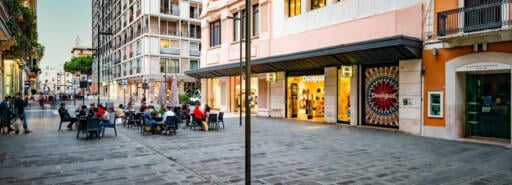 Via Sparano façade with visitors seated at tables on the street