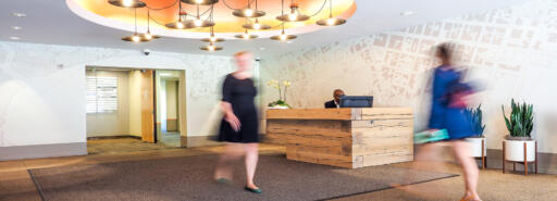 People walk through the lobby of Waterfront Plaza