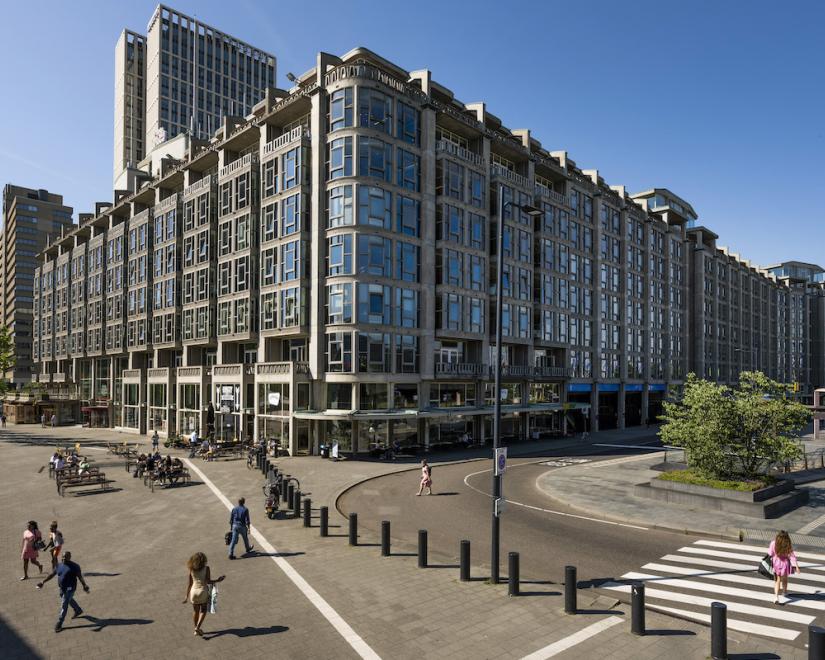 Groot Handelsgebouw on a sunny day with pedestrians walking all around