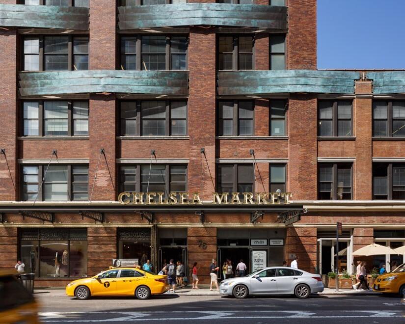 Facade of Chelsea Market with New York City yellow cabs out front