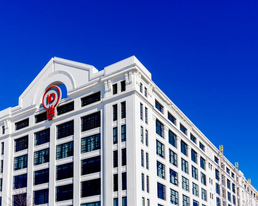 The exterior of The Innovation and Design Building under a clear blue sky