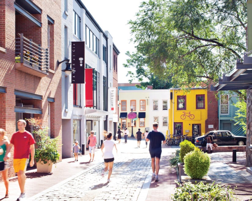 People walking in sun bathed streets of Cady's Alley