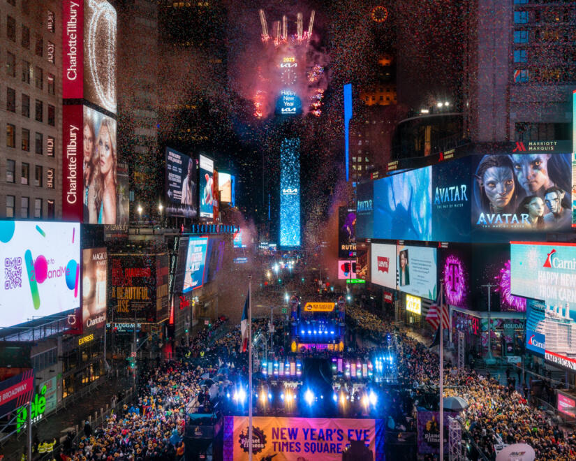 Massive crowd in Times Square for New Year's Eve celebration with ball drop and fireworks on the One Times Square building