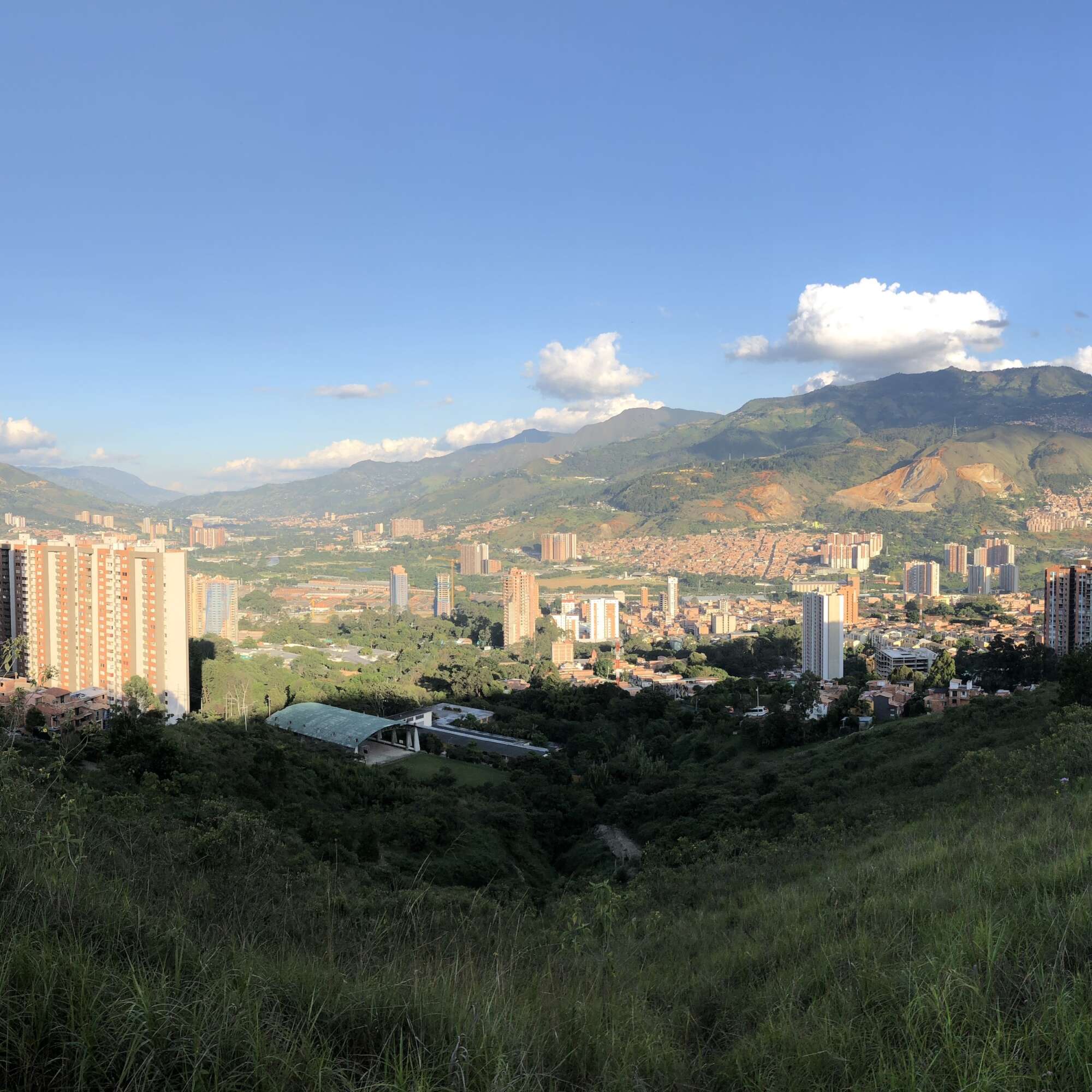 View of a green lush valley and buildings scattered throughout
