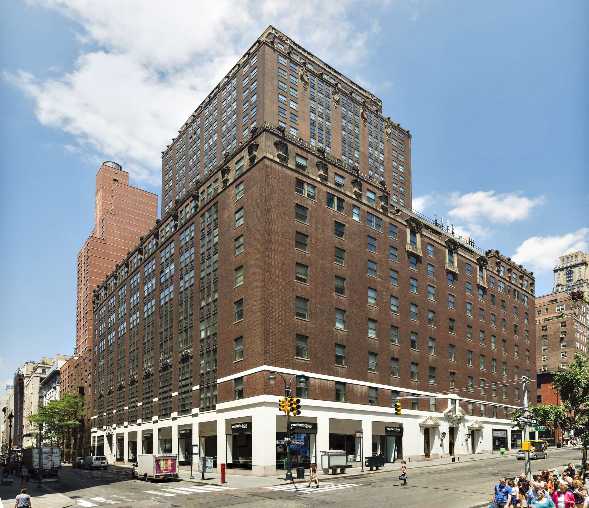 200 Madison building facade at corner of intersection with pedestrians on sidewalk