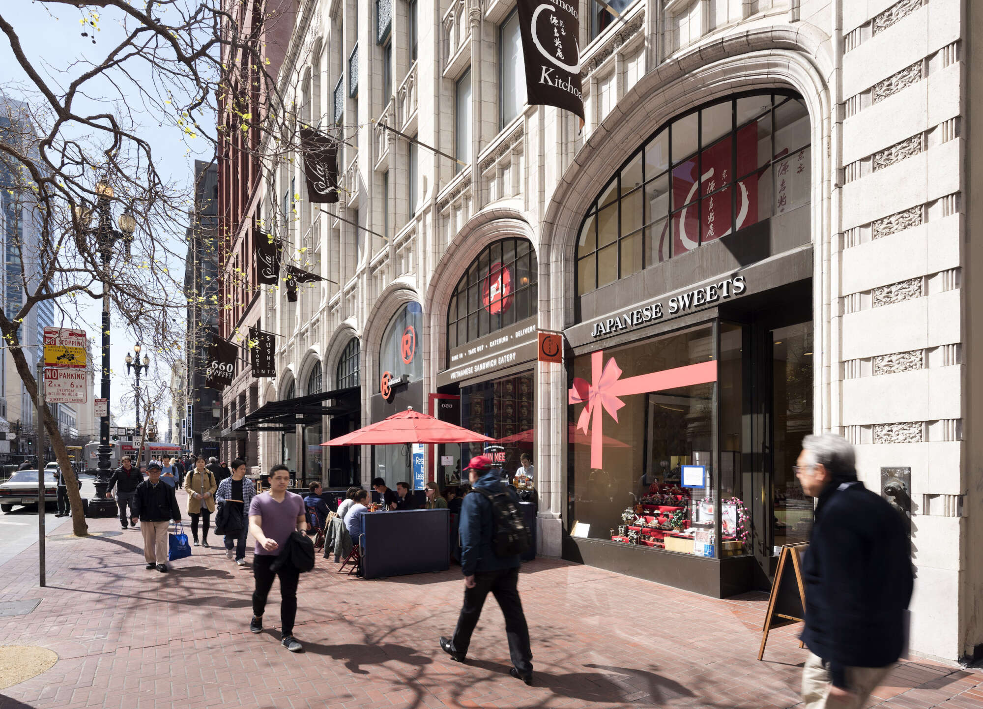 660 Market retail store facades with pedestrians on sidewalk