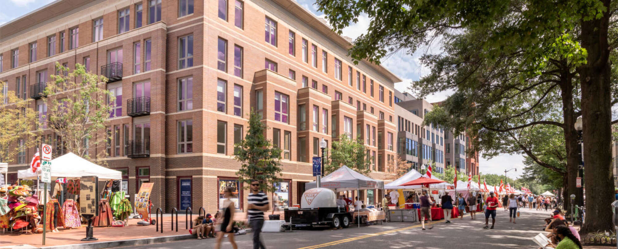 700 Penn building facade with street fair tents and pedestrians