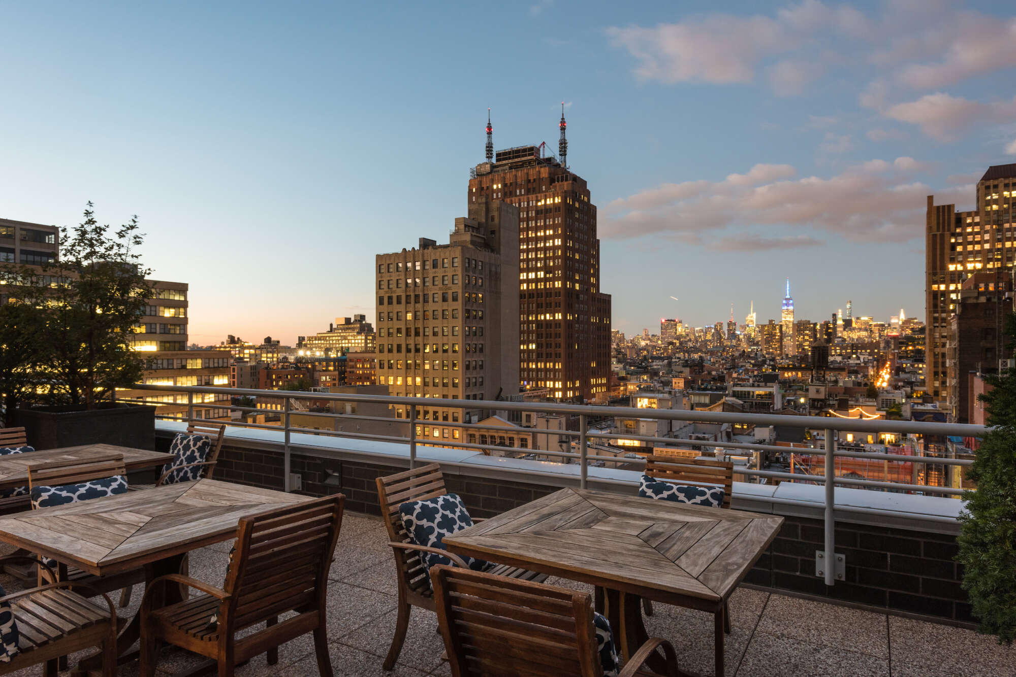 88 Leonard rooftop deck at dusk with skyline in background