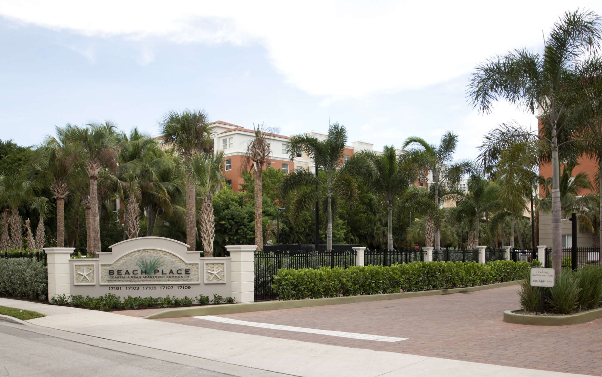 Beach Place main entrance driveway with monument sign and palm trees