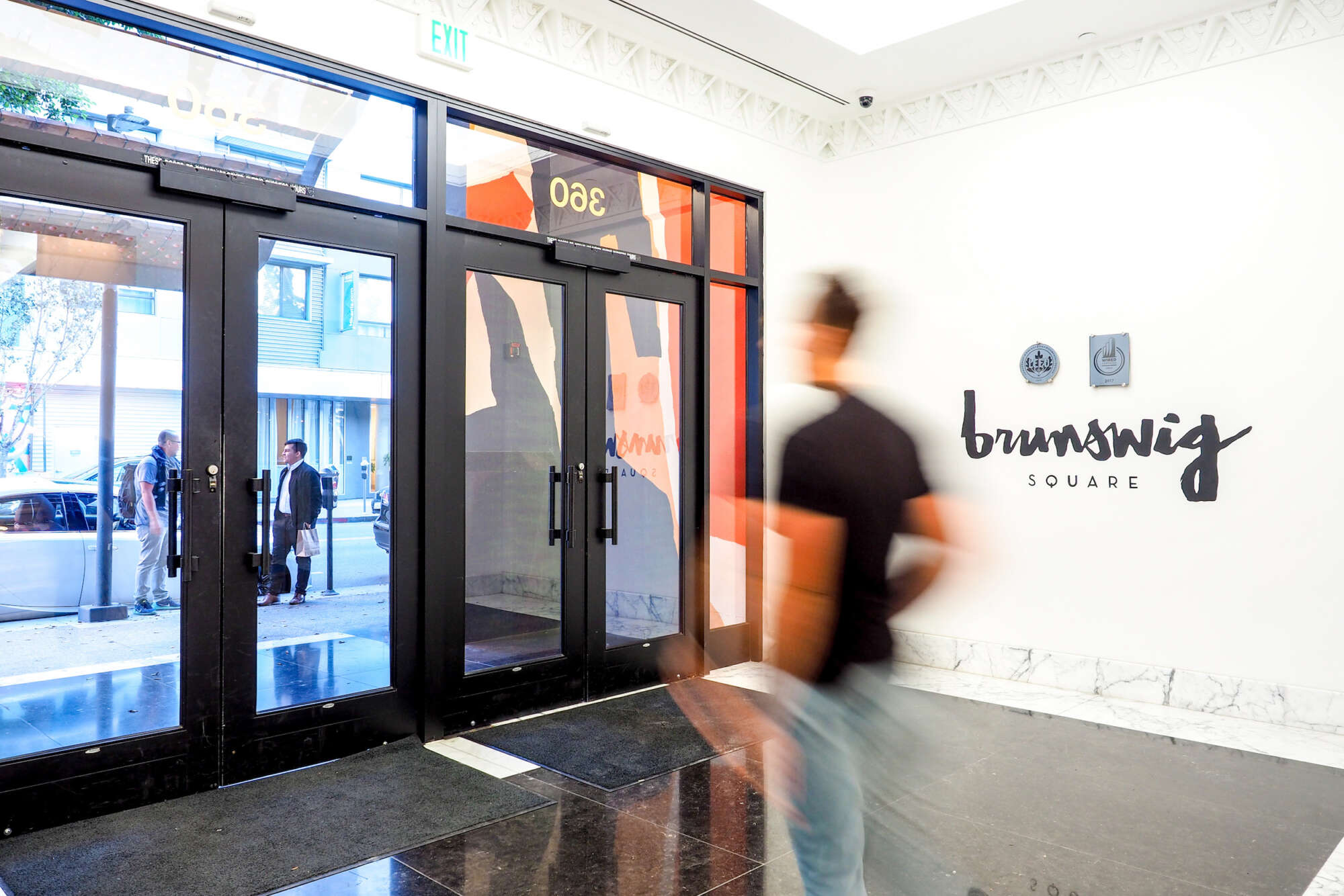 Brunswig Square lobby with visitor walking towards doors