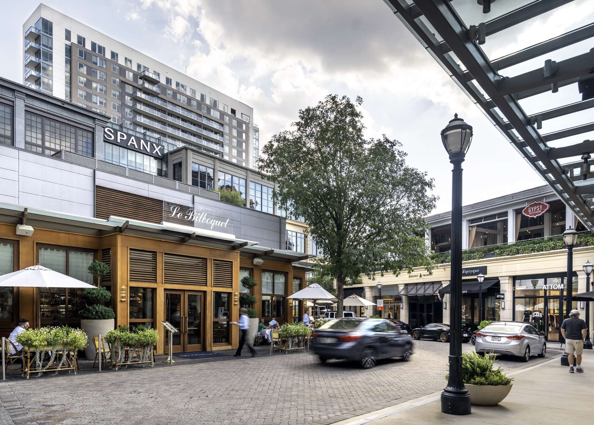 Street at The Shops Buckhead Atlanta with a car driving by