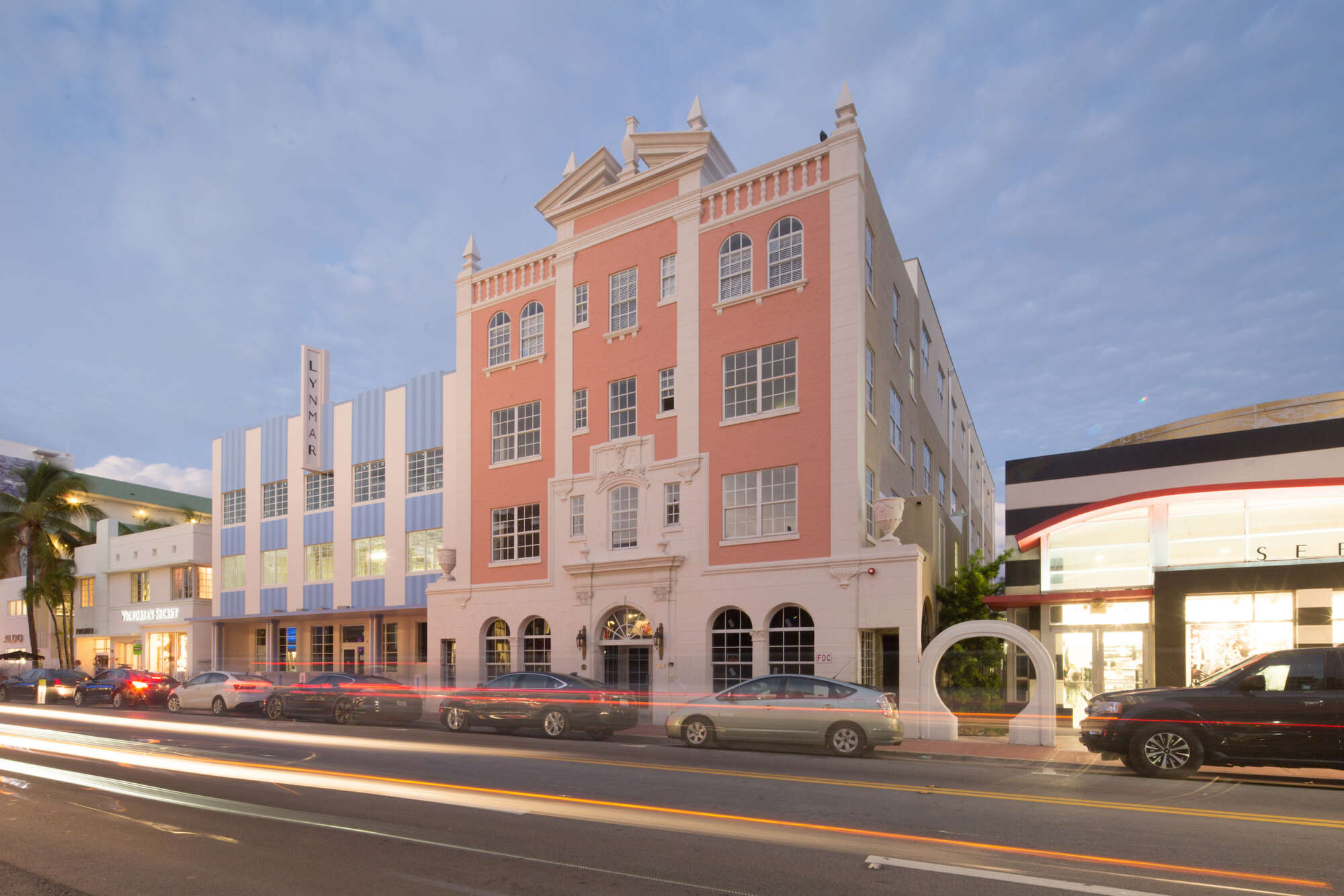 Collins Avenue Collection in the evening with cars moving past