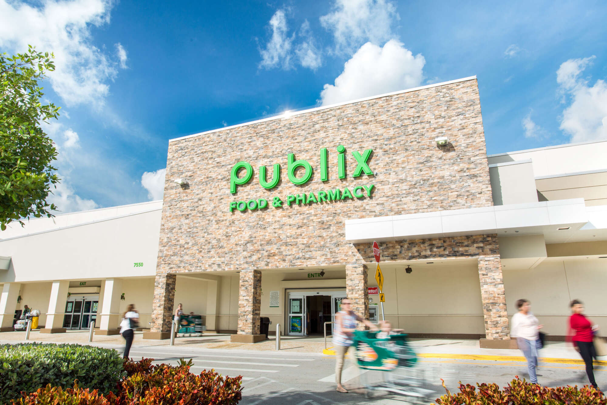 Doral Commons grocery store exterior with pedestrians crossing driveway