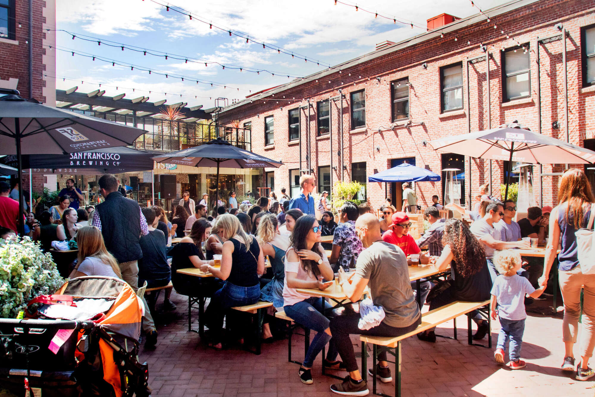 Ghirardelli Square restaurant patio with guests seated at tables under umbrellas