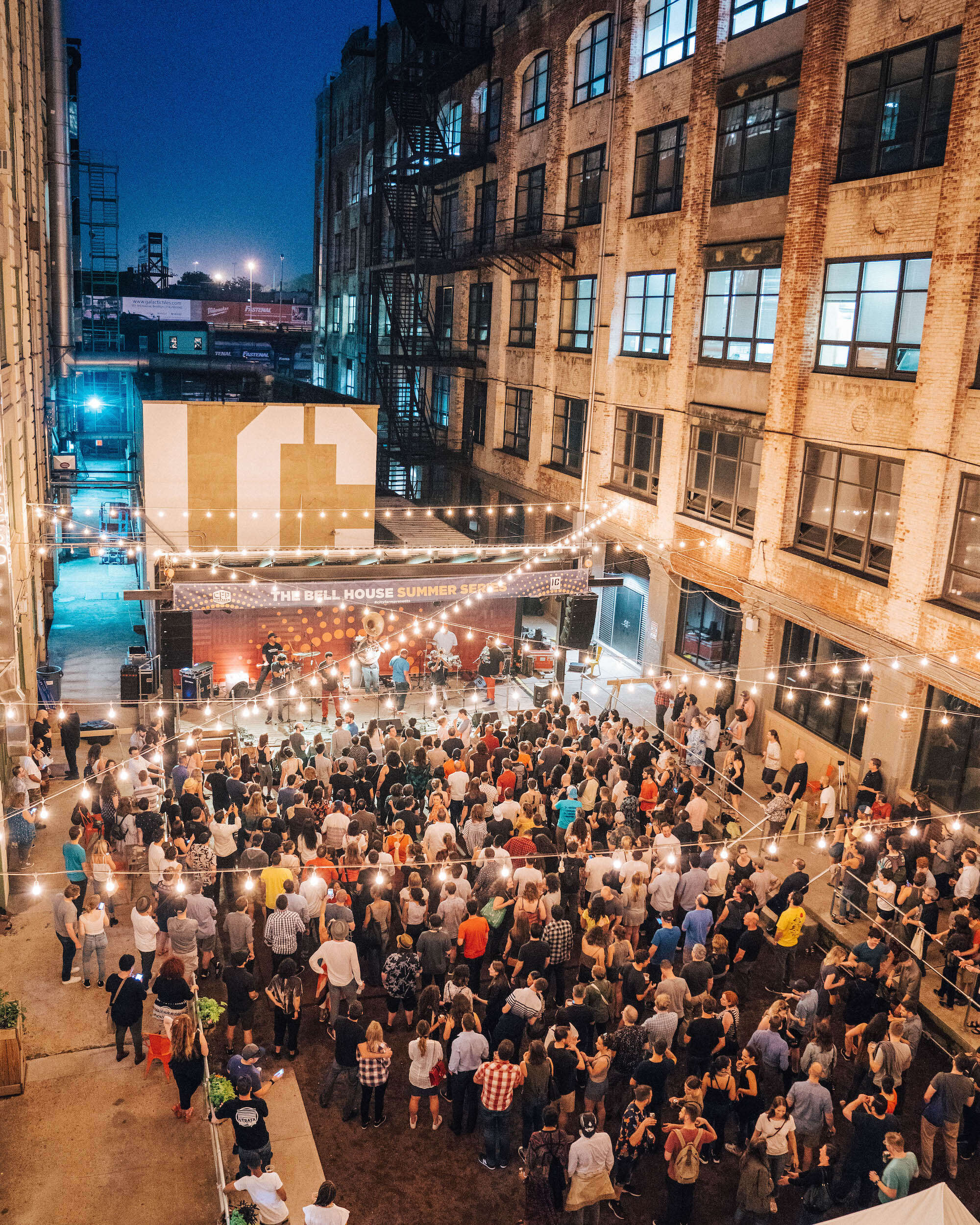 Industry City courtyard at night with attendees at an event
