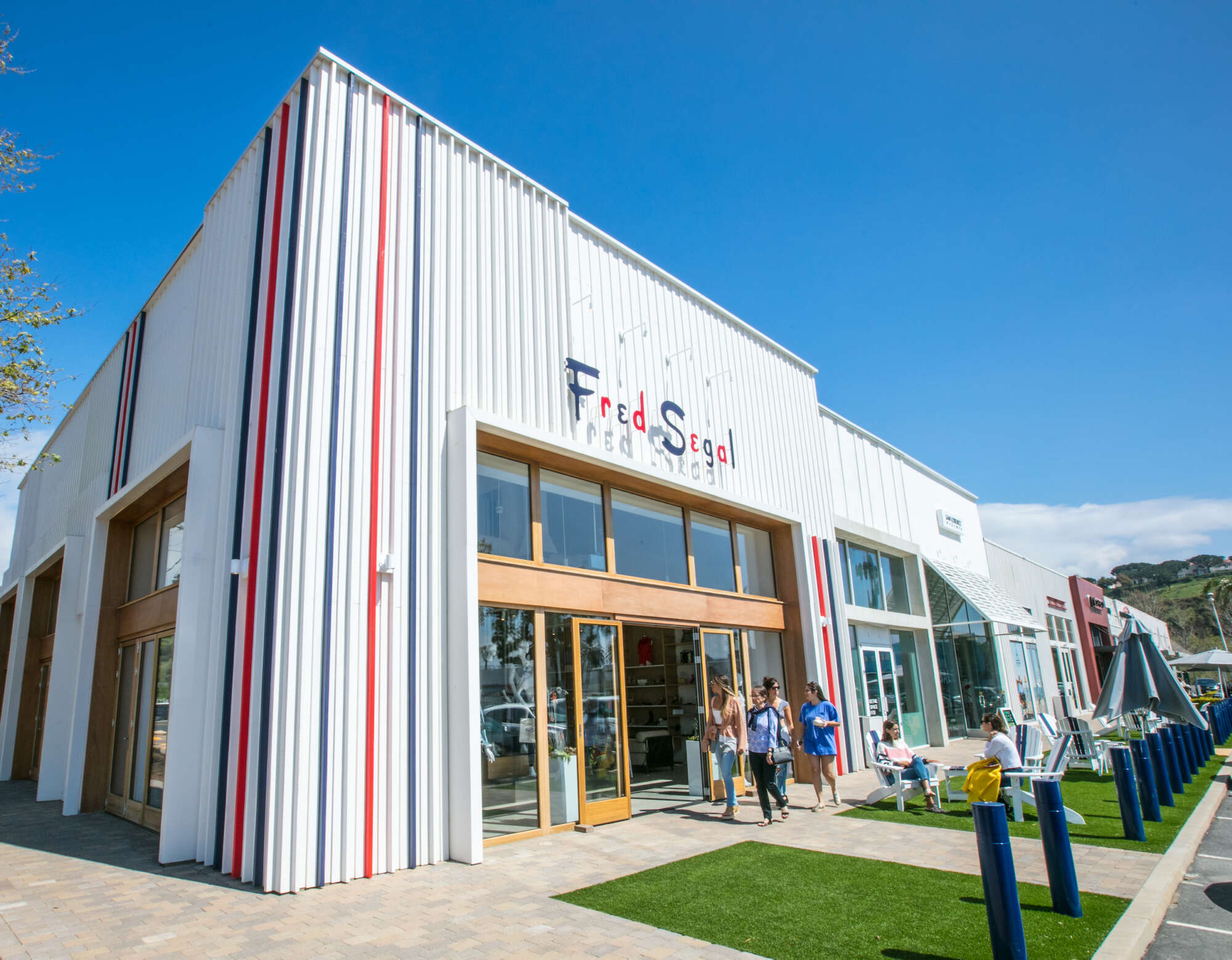 Exterior of Fred Segal in Malibu with people walking on the sidewalk