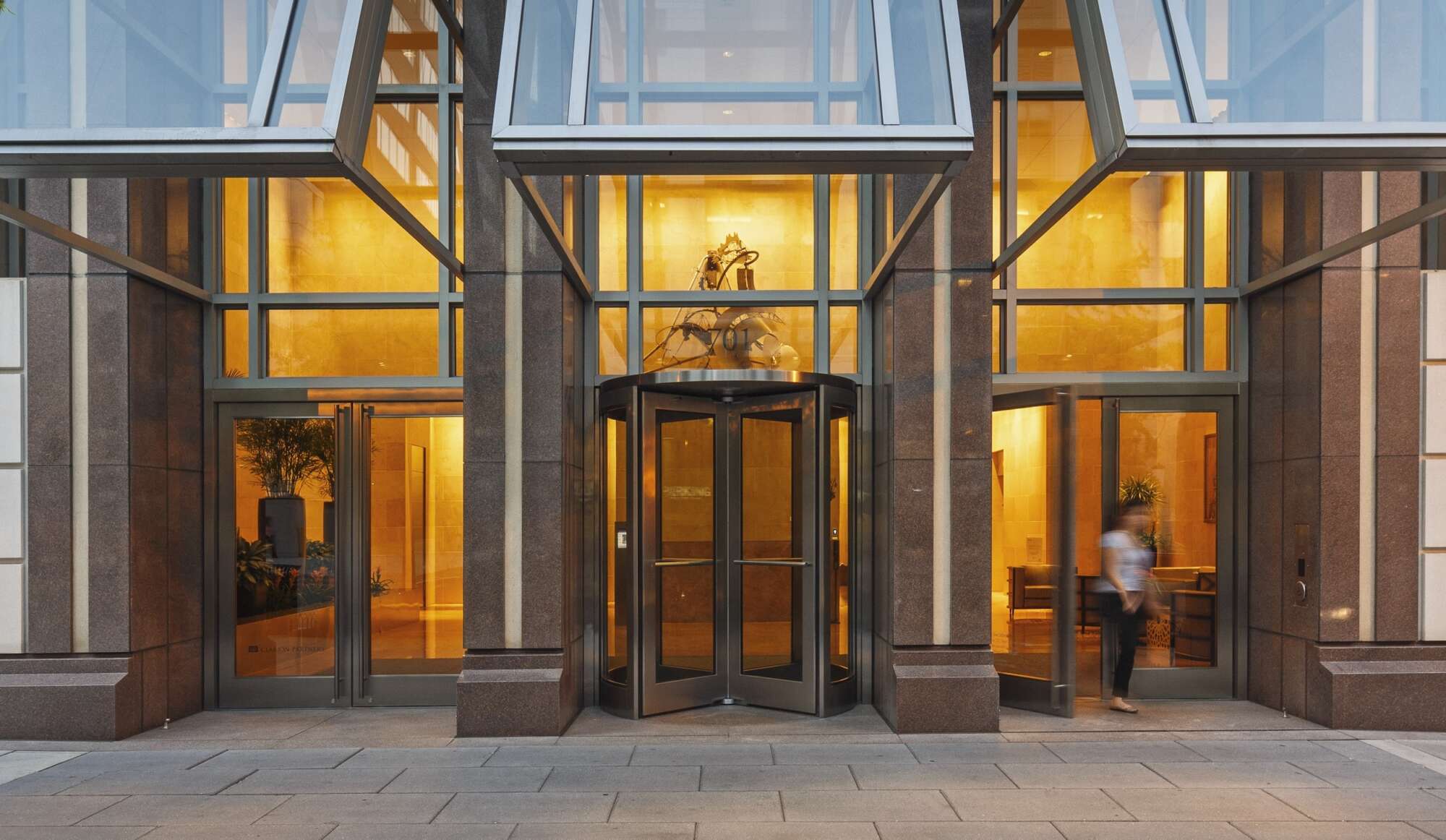 Street level exterior of One Metro Center with person walking out the door
