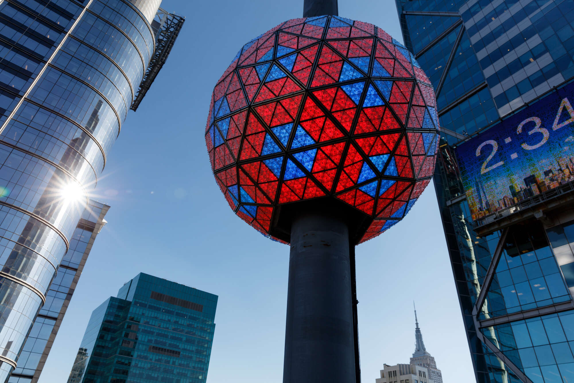The large crystal New Year's Eve Ball on the top of One Times Square is lit red and blue.