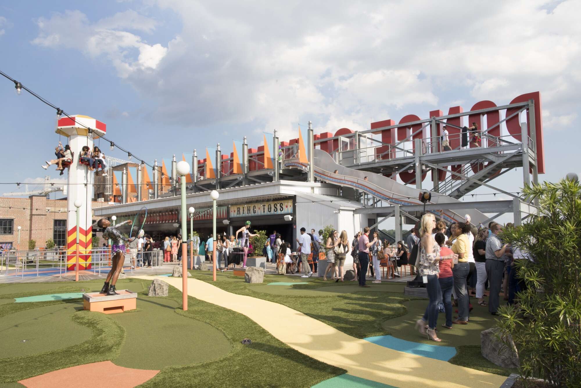 People out enjoying the amusement park and nice weather on the top of Ponce City Market