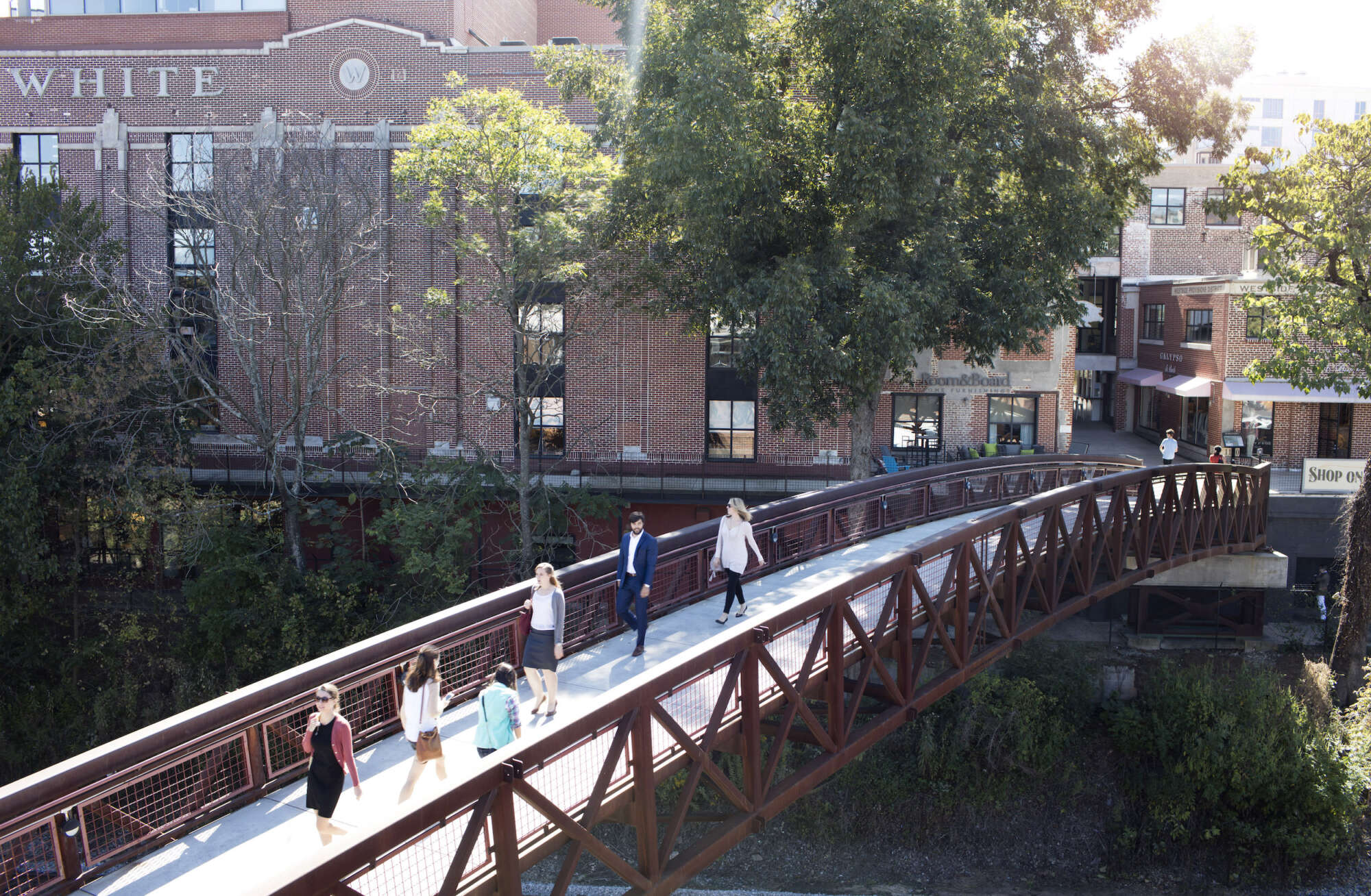 View of the bridge at Westside Provisions District in the daylight with people crossing over