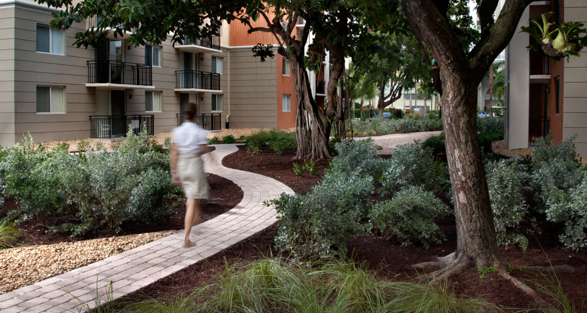 Woman walking on pedestrian path in Beach Place outdoor common area