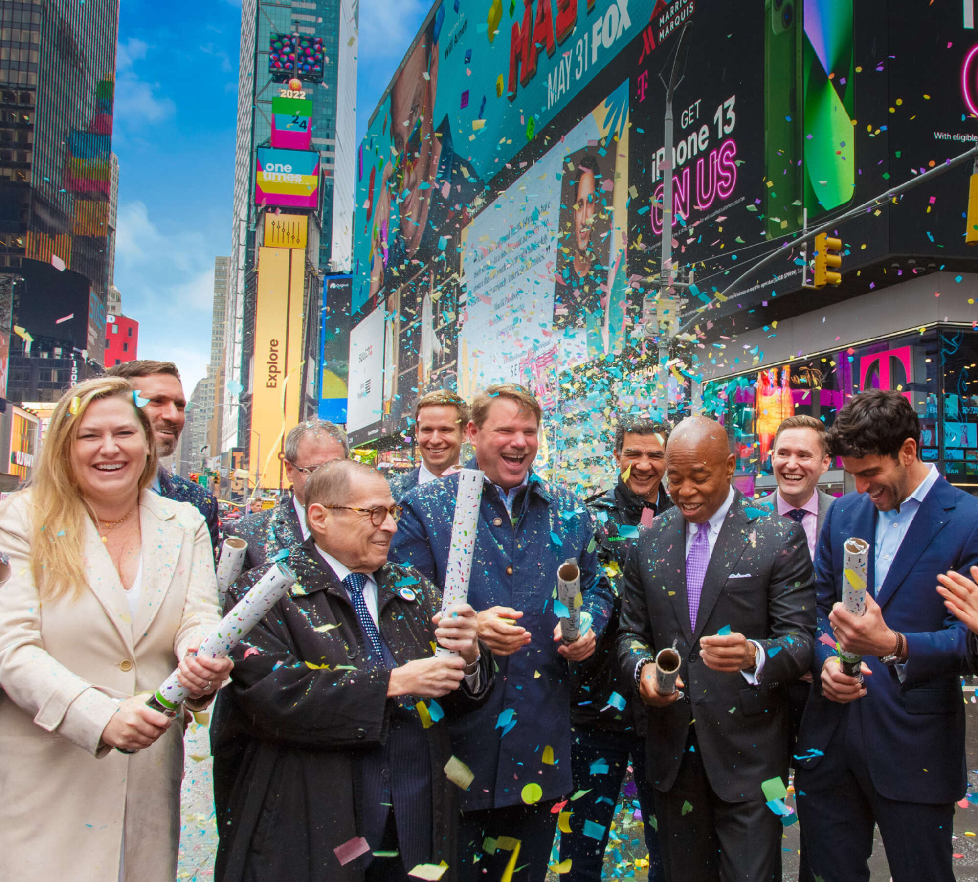 People gathered in Times Square launching confetti to celebrate the announcement of One Time Square's redevelopment